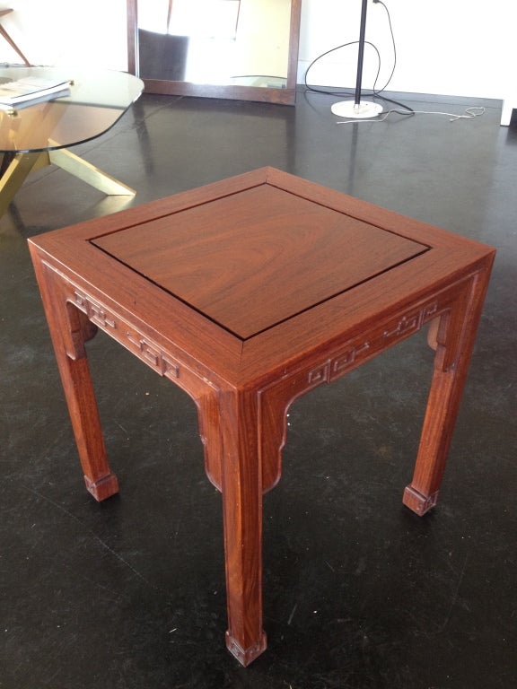 A very nice pair of solid rosewood end/side tables produced by J.L. George, a Hong Kong based fine furniture maker throughout the 20th century. Lovely carved design on feet and apron of each table. The rich rosewood grains and color makes these