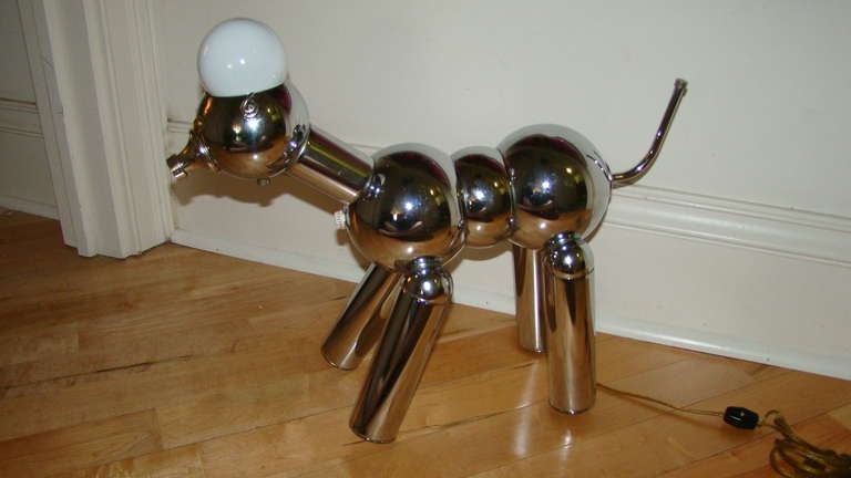 Exceptional and hard to find Robot Dog Lamp by Torino Lamp Company. This playful lamp is comprised of a chrome frame and takes one bulb on the head which lights up the eyes. . The dog is very hard to find as compared to the robot lamps by Torino