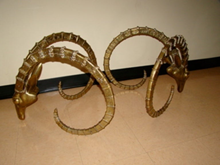 Exceptional Sculptural Solid Brass Gazelle Ibex Coffee Table in the manner of Leon Francois Chervet. This beautiful design is comprised of solid brass/bronze in the form of highly detailed Rams Heads. Truly a beautiful design in person! Glass top