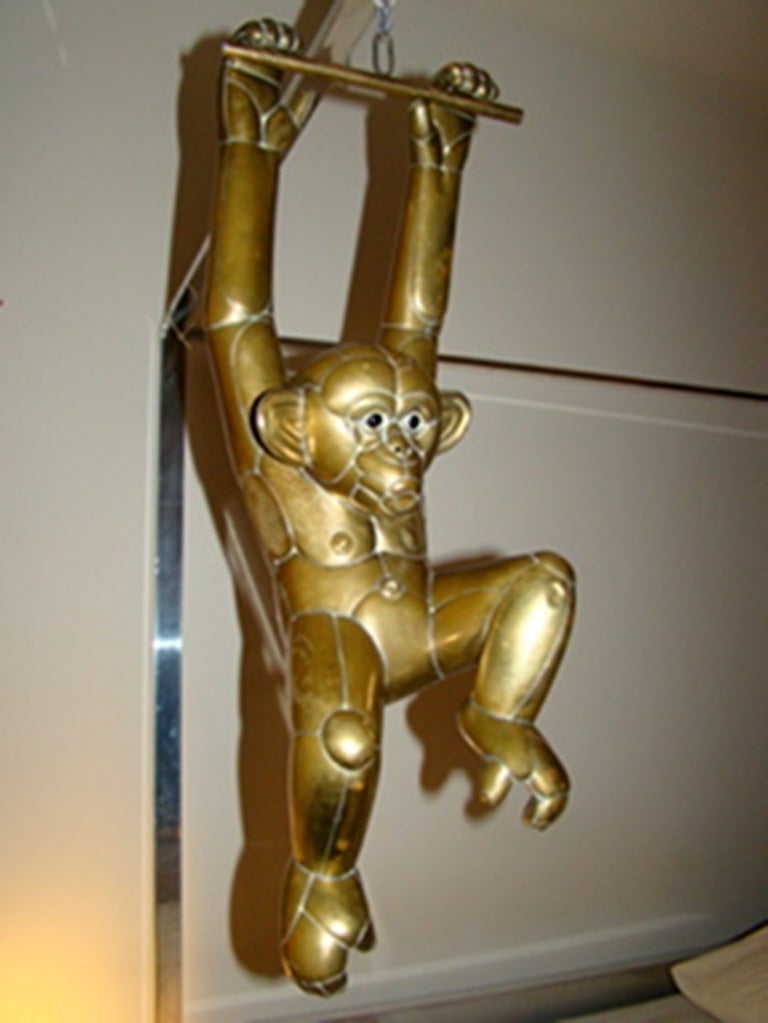 Outstanding Mixed Metal Monkey Sculpture by Mexican Master Sergio Bustamante. Comprised of brass & copper patchwork with glass eyes depicting a whimsical monkey hanging from a bar. Signed & Dated Sergio Bustamante 15/100.