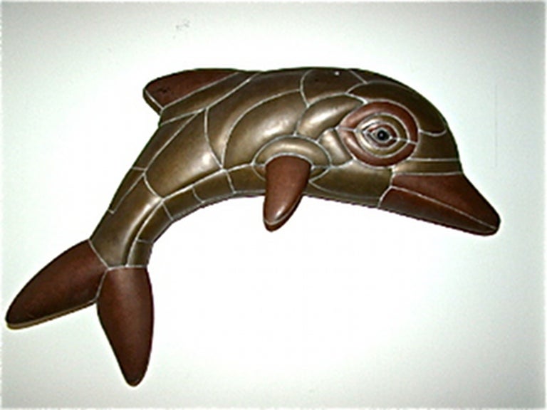 Exceptional and rare mixed metal Dolphin Sculpture by Mexican Master Sergio Bustamante. Comprised of welded brass & copper pieces in the form of a playful dolphin with glass eye. Signed & numbered Sergio Bustamante 5/50.
