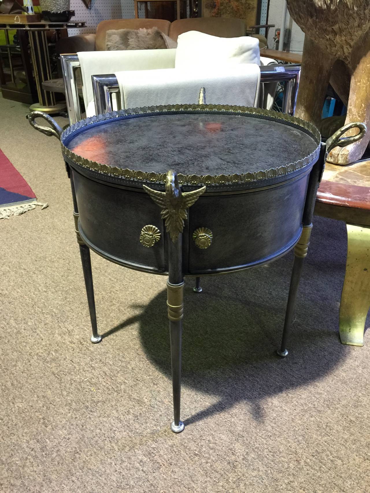 Exceptional Mid-Century tray table by Trouvailles. Comprised of a sculptural steel drum form with brass swans on each corner and removable tray top. Signed 