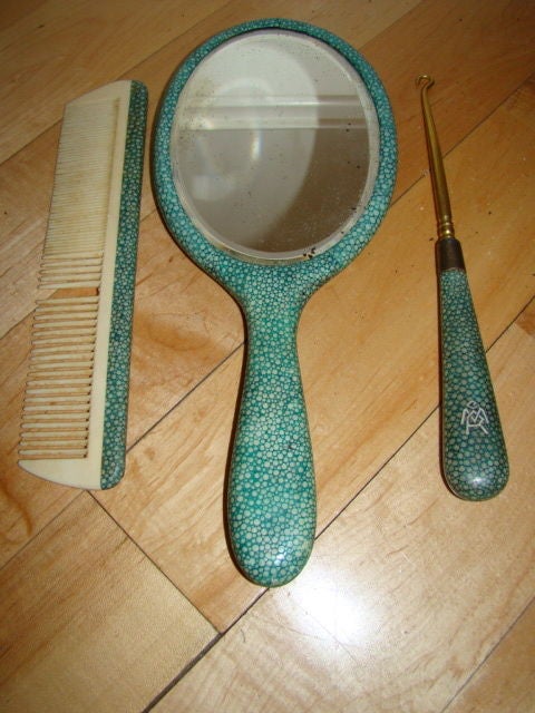 Supurb Art Deco English Shagreen Vanity Set. This beautiful all original set is comprised of real shagreen and consits of a hand mirror, comb, and button hook. The mirror and hook have an inlaid monogram of CMR with bakelite.