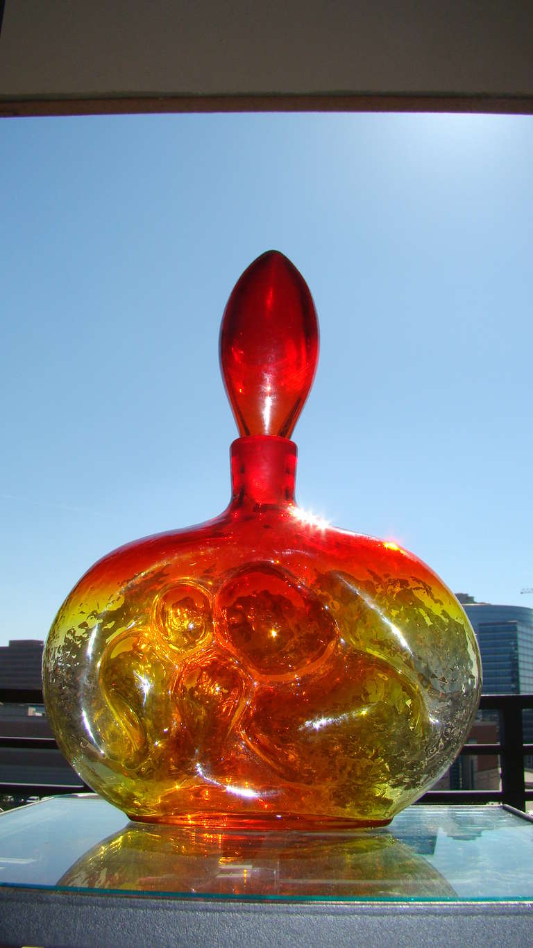 Terrific 1950s Blenko Glass Decanter designed by Wayne Husted Model 6310. This hard to find piece is comprised of hand blown glass with sculptural bubble front in orange & yellow tones. Truly a beautiful decanter in person.