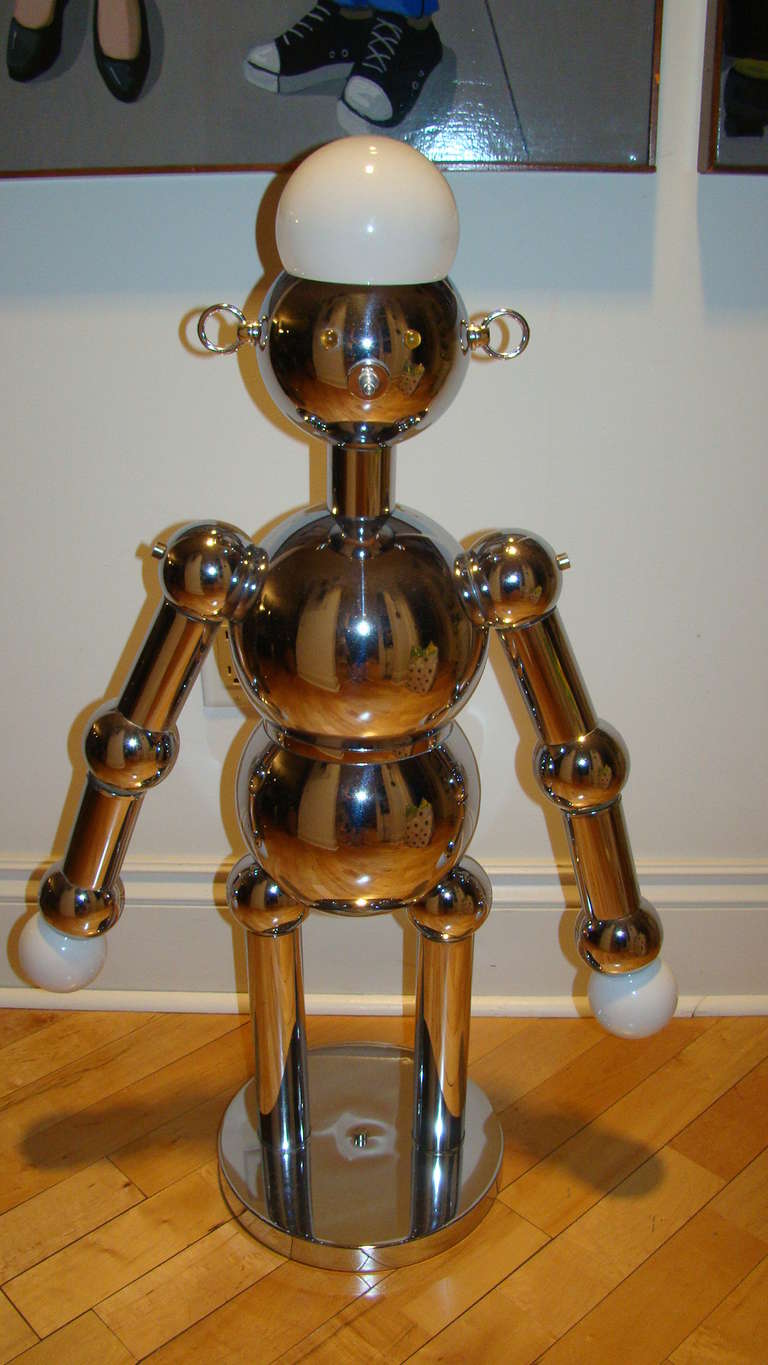 Exceptional and hard to find Robot Lamp by Italian company Torino. This playful piece is comprised of a chrome body in the robot form and is the largest model produced.  The three way switch on the nose allows for each of the bulbs to be turned on