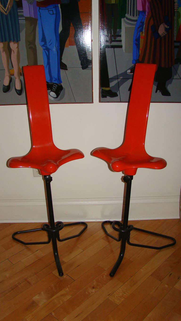 Exceptional and hard to find pair of Oppogio Stools designed by Italian Master CClaudio Salocchi for Sormani. This unique design is comprised of original orange fiberglass body with black metal adjustable bases. Truly a unique sculptural design in