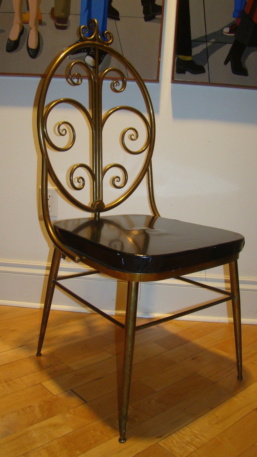 Beautiful and hard to find Italian brass Chiavari chair in the manner of Gio Ponti. This unusual design is comprised of a sculptural brass flowing form with intricate design and original black seat. Truly a special chair in person!