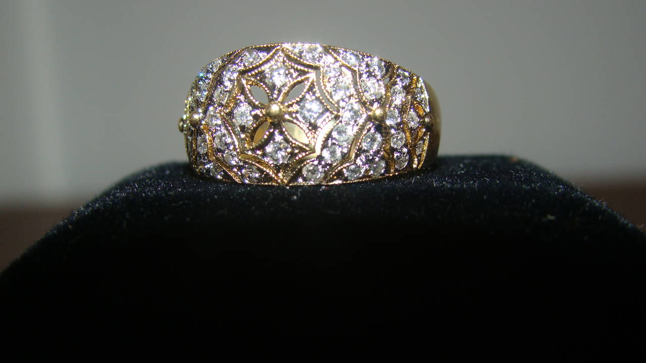 Outstanding 18-karat gold antique pave diamond ring. This beautiful ring is comprised of solid 18-karat gold with 46 full cut round diamonds. The diamonds are perfectly matched and exceptionally bright with a gem weight of over half a carat, stamped