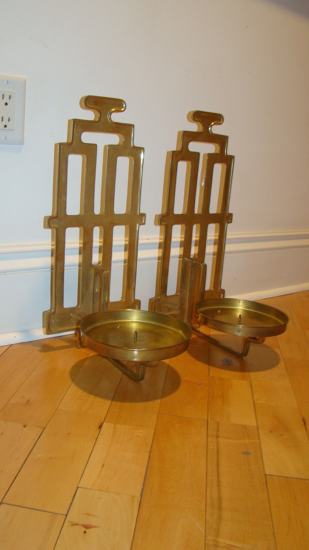 Beautiful pair of sculptural brass Mid-Century candleholders by Sarreid. This interesting pair are comprised of solid brass and can be hung on the wall or used on a table. Signed with Sarreid labels.