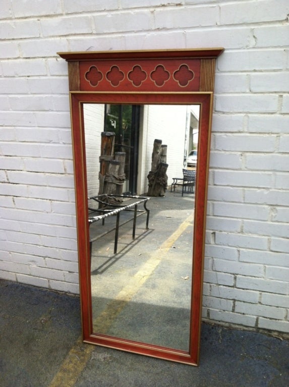 Glamorous Wall Hanging Mirror by Dorothy Draper for Heritage. This beautiful piece is comprised of an orange painted wood with intriquite brass details. Truly a beautiful design in person!