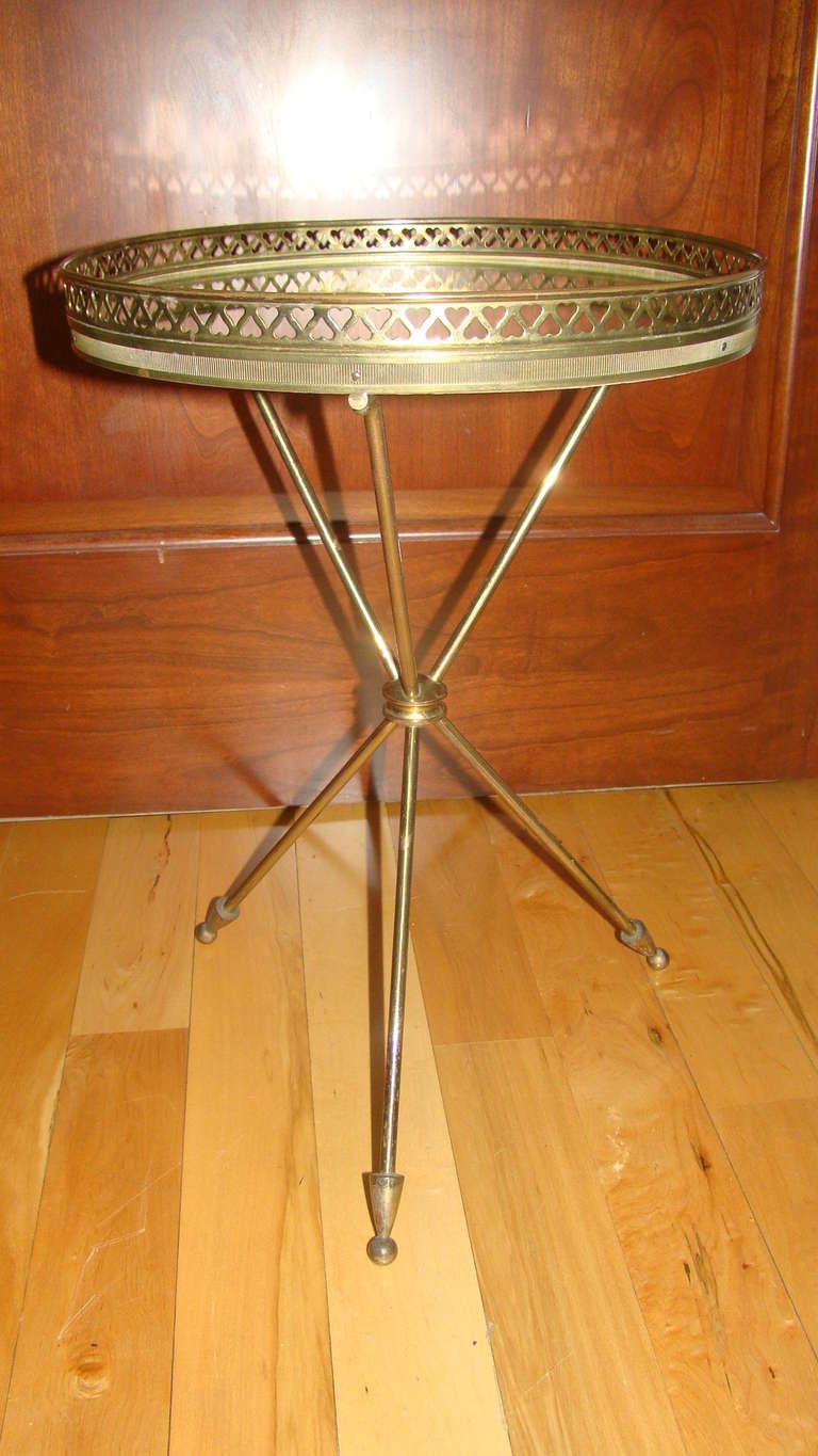 Exceptional Mid Century Brass & Mirror Top Tripod table in the style of Gio Ponti. Comprised of a brass heart shaped rim with mirror top and brass base.