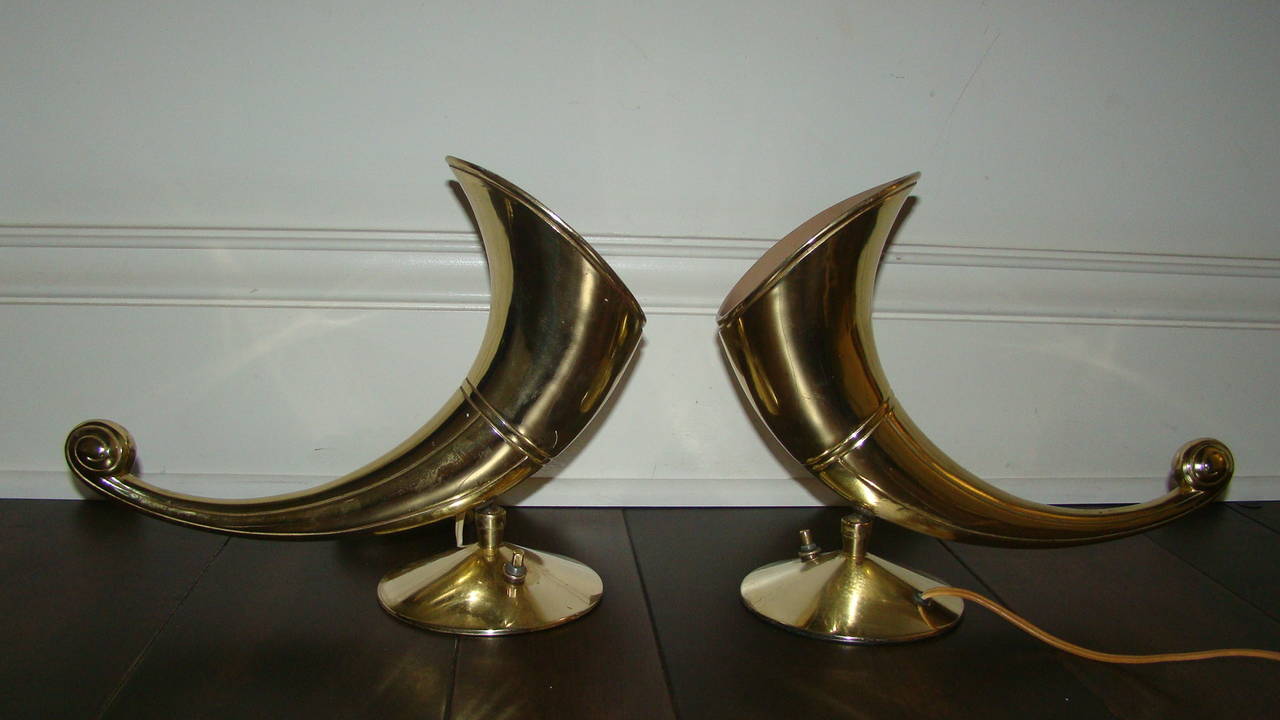 Tremendous pair of sculptural brass horn lamps by Stiffel. This unusual design is comprised of solid brass with pivoting heads so you can direct the light. Truly a unique pair of lamps in person.
