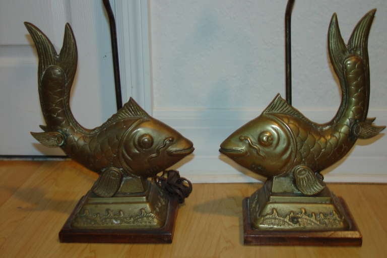 Pair of Brass mid century Fish lamps from the 1960s to early 1970s. Highly detailed with wood bases. Priced as a pair.