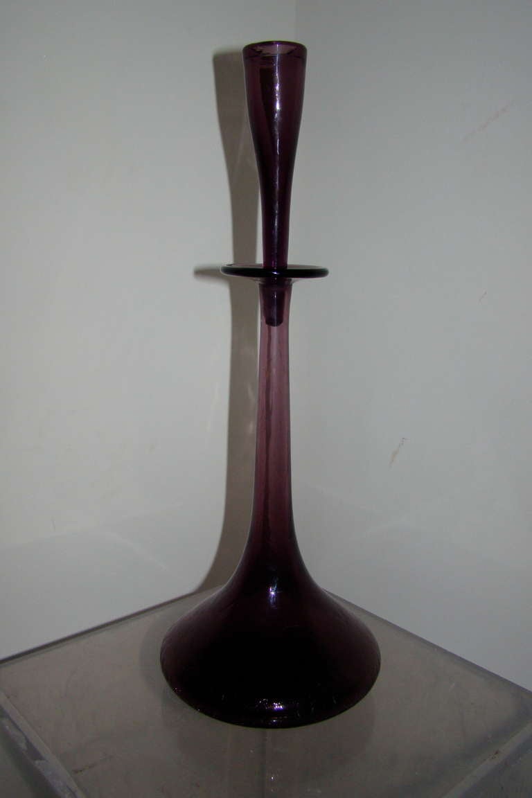Beautiful and hard to find Blenko Glass Shot Glass decanter model 6027 designed by Wayne Husted. This piece dates to the early 1950s with acid etched Blenko mark. It features a purple hand blown glass with crackle bottom and shot glass stopper.