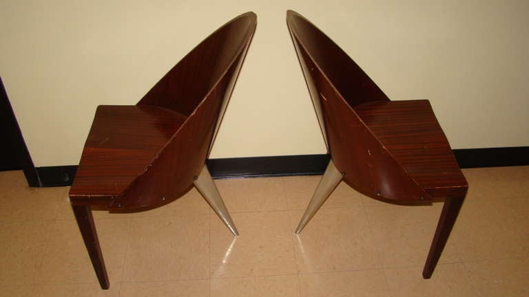 Terrific pair of chairs designed by Philippe Starck for the Royalton Hotel in the 1980s. These chairs were never produced and custom made for the hotel so they are very hard to come across. Comrised of stainless back legs with mahogany wood frame.
