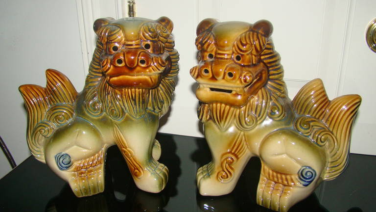 Great pair of midcentury glazed pottery Foo dogs. Each is comprised of a hand-painted glazed pottery in earth tone colors of brown, tan and green. Fine addition to your modern decor.