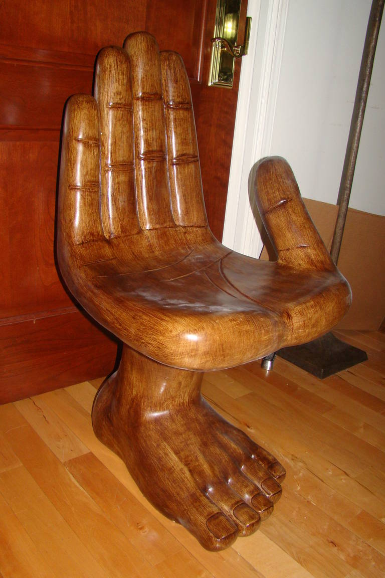 Terrific Mid-Century sculptural hand and foot shaped chair in the style of Pedro Friedeberg, circa 1980s. This unique design is constructed of a faux wood finish and swivels a full 360 degrees. Truly a unique statement piece for any home.