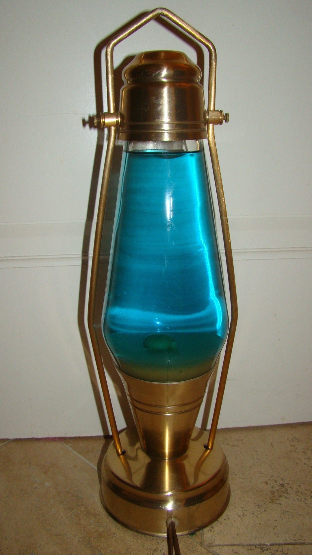 Terrific vintage coach lantern lava lamp. This interesting piece is comprised of a copper lantern style frame with blue liquid and green lava.
