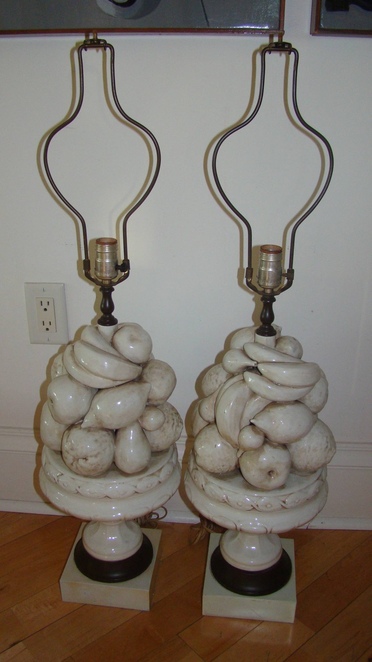 Exceptional pair of matching Italian pottery or ceramic fruit bowl table lamps. Each is comprised of a sculptural stack of fruit in white pottery form. Signed on the inside 