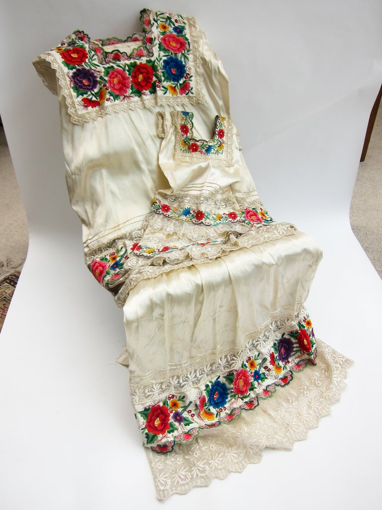 It is very unusual to find matching dresses of any kind here in Mexico and what makes this set so endearing is the mother/daughter element. This traditional dress of the Yucatan peninsula is made up of a huipil which has a smooth frill with