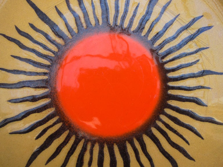 Beautifully crafted copper plate enameled with a gold background for a sunburst design in orange red and black. A strong composition by Miguel Pineda who was born in Mexico City in 1940 and is considered one of the foremost enamelists of Mexico. His