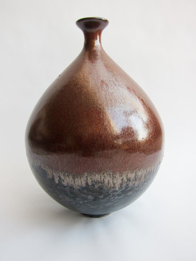 Stunning ceramic form with metallic glaze overlay of copper oxides over a black undercoat.
Ian Knizek, (1916-2001, Czech Republic) was a chemical engineer and mineralogist. His vocation was the experimentation of ceramic material and its scientific