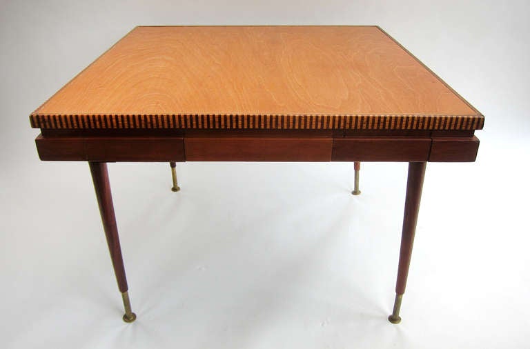 A very handsomely designed game table done in mahogany & cedar with a brass and marquetry rim accent. Drawers & pockets are lined with the traditional green felt and mahogany legs have solid brass extensions. Chairs are mahogany with brass detail