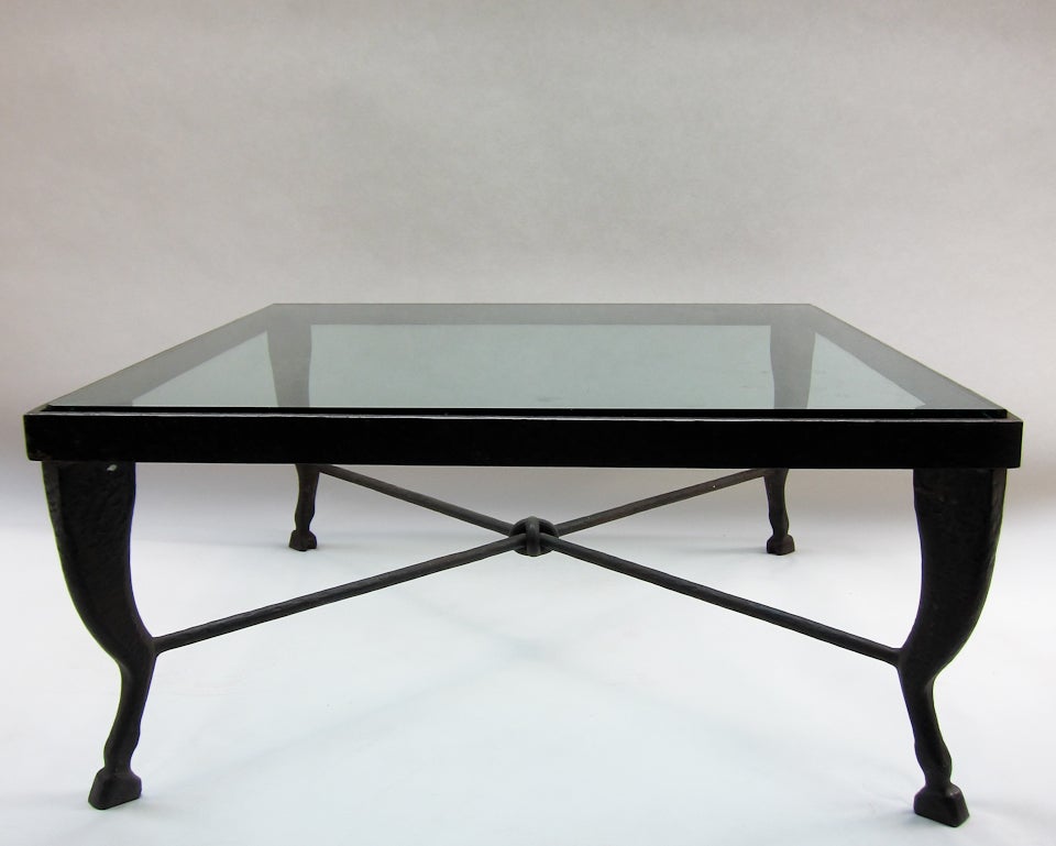 This table is the work of an elite metalsmith who has applied the art of forge-welding; the entire piece is one single unit which has been joined with the blows of a hammer while the pieces were hot. Decorative hammering has been applied throughout