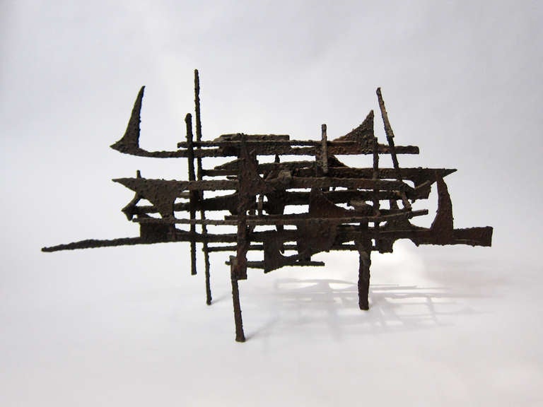 In this composition Enrique Miralda (Honduras 1933-2010 Mexico City) has welded iron strips to form this free standing ship like sculpture which from every angle offers a compelling study in lines and space.

A student of architecture and