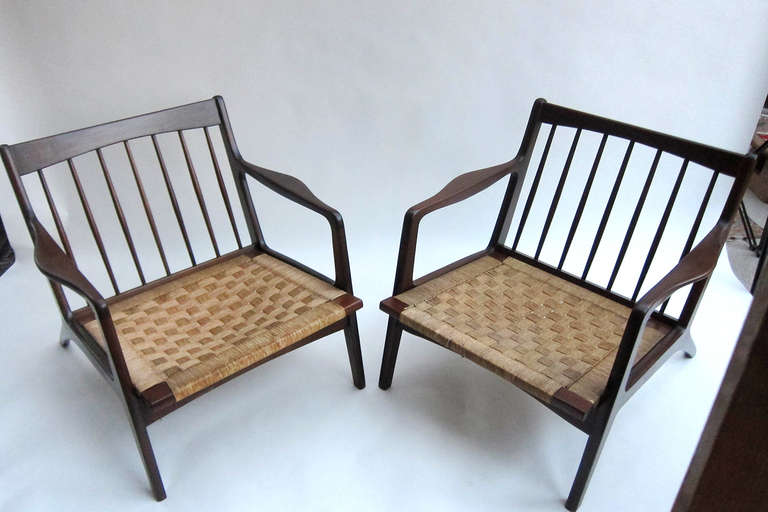 This is a wonderful pair of lounge chairs constructed of cedar and mahogany with the original woven natural palm fiber seats. The weaving of palm leaf for mats, baskets, rope, and seating among other items dates back to pre-hispanic times and is a