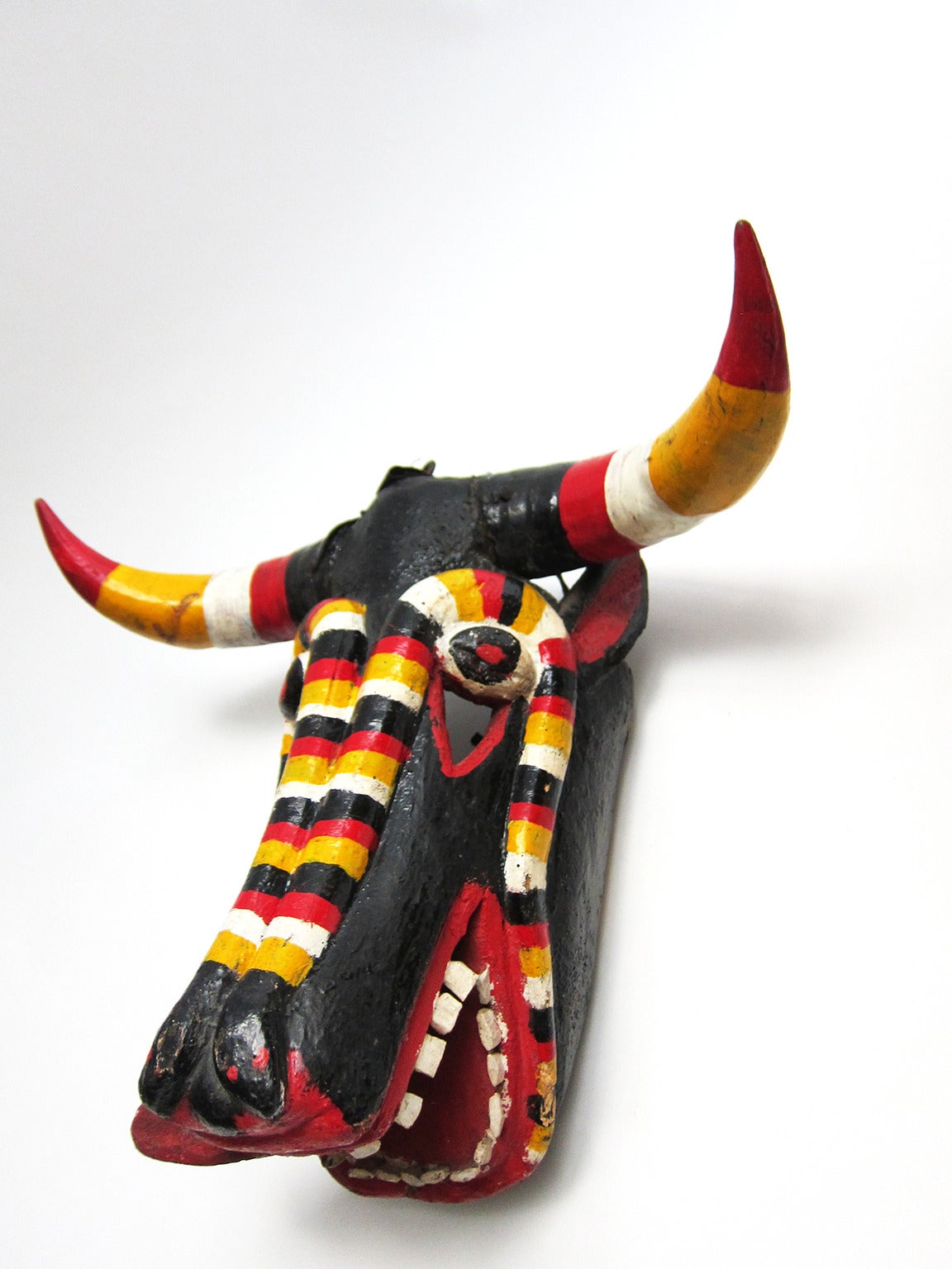 This mask is from Silao, Guanajuato from the Muyaes collection. It is hand carved polychromed wood with natural horns and is intended to depict the devil, with its horns and dominant red paint. Danced in the pastorela celebration (a Christmas drama)