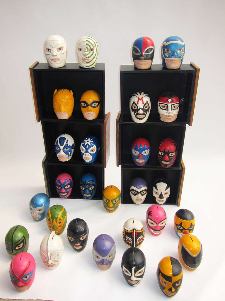A wonderful collection of masked luchadores (wrestlers) in the form of banks - a popular prize item formerly given at fairs here in Mexico. Hand painted on cast plaster, these masks are considered sacred to the men who wear them and it is a dishonor