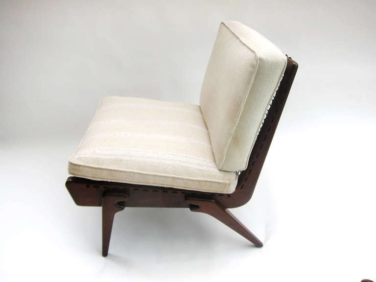 Constructed at an angle meant for comfort with the carved sleek legs at the perfect position to support the structure, this chair of mahogany which has a walnut tint, was done by Charles Allen for Regil, a mid-century furniture company in the