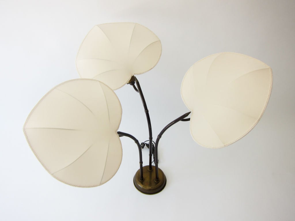 An elegantly executed design from the studio of Arturo Pani, who with his architect brother Mario Pani, was credited with bringing modernism to Mexico City in the mid-century. Beautifully crafted lamp in brass. Palm leaf shades have been custom made