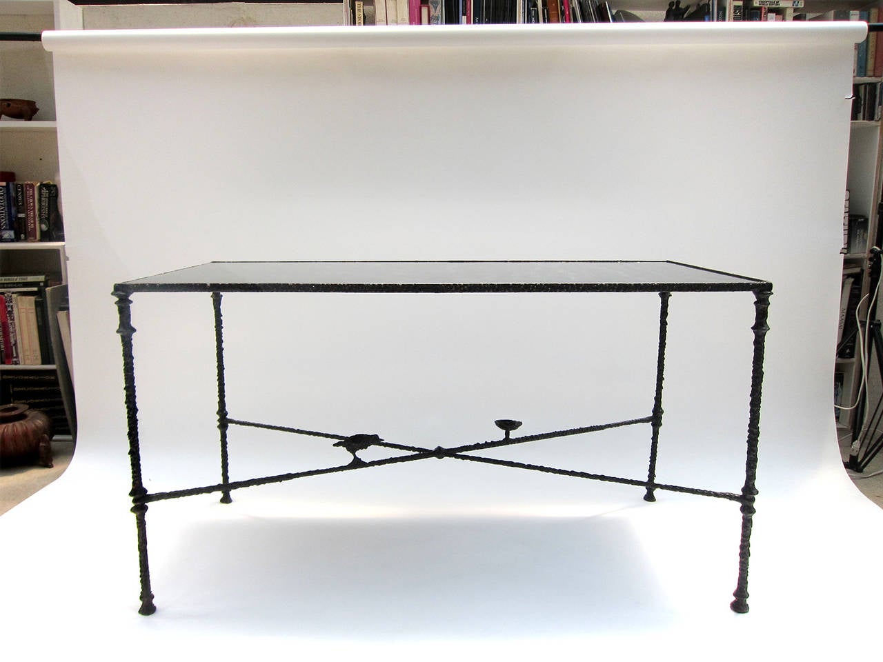 Beautifully executed table in the manner of Diego Giacometti with a églomisé glass top. An extraordinary re-creation in iron from an unknown artist who has adhered so faithfully to the premier designer’s method that he seems to have made it as a