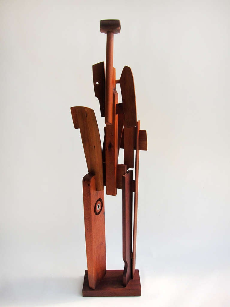 A powerful yet whimsical cubist interpretation of a female figure by sculptor Jose Luis Venegas Martinez. Beautifully constructed of joined cedar and mahogany, this piece aptly demonstrates the artistic skill of this sculptor.  Born in Mexico in