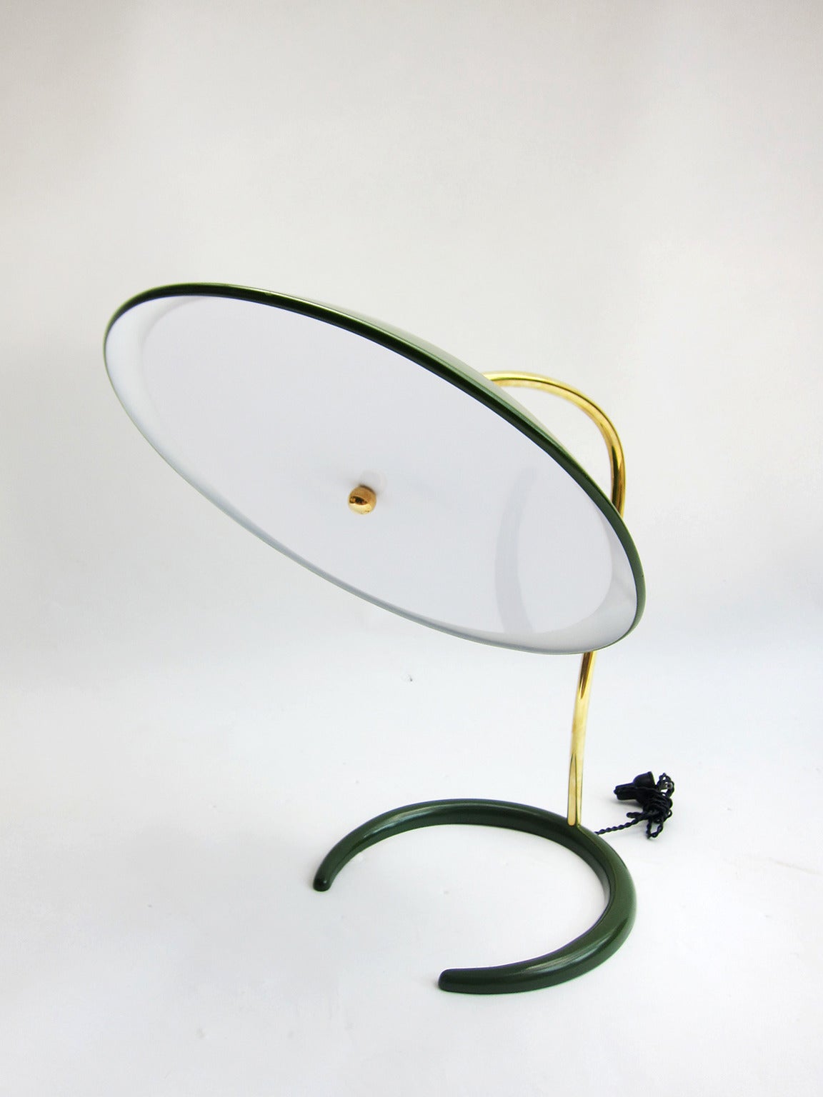 Circular (adjustable) dome over crescent base separated by a curved brass rod, this lamp by Gerald Thurston is a standout for its simple grace. As with all lighting designed by Thurston, who designed for Lightolier in the 50’s and 60’s, a