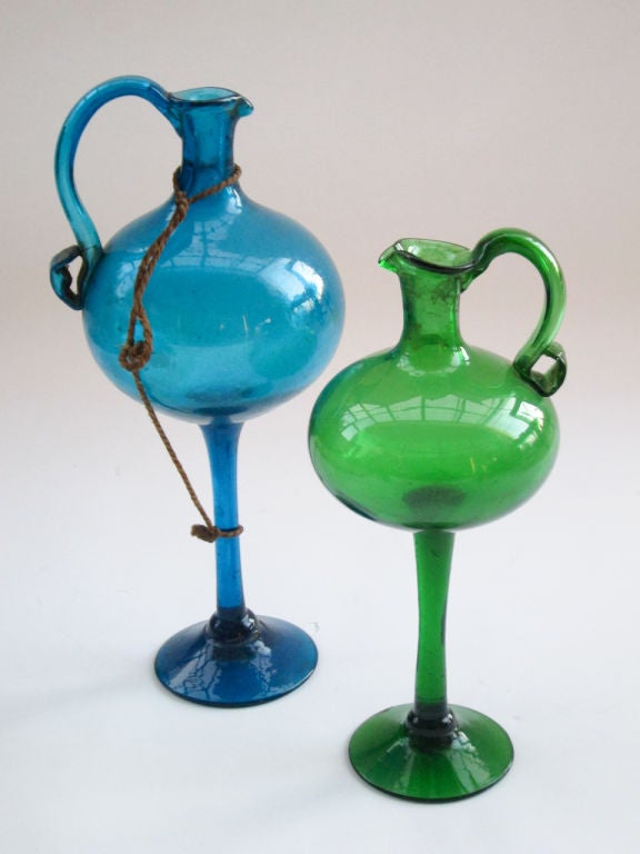 3 hand blown decanters of colored glass done in the 1940’s here in Mexico, the design dating from the 17th century. The large stem decanters were for oil and vinegar and the smaller decanter with the ‘de puntilla’ design was for liqueur. That they