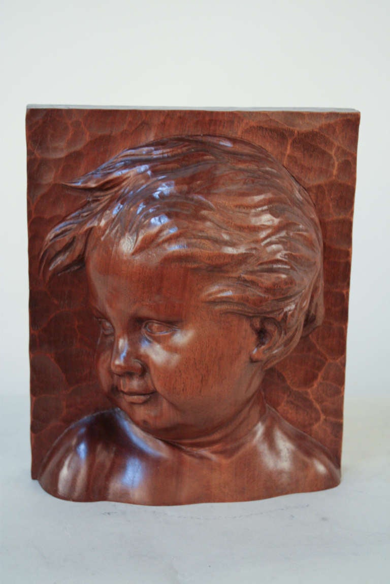 An excellent early 20th century sculpture. A hand carved bust of a child, this fantastic carving was created by noted artist Elordet.