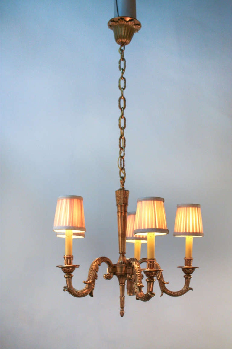 An elegant French chandelier. Made during the 1930's, this five light fixture's ornate bronze design really is something special.