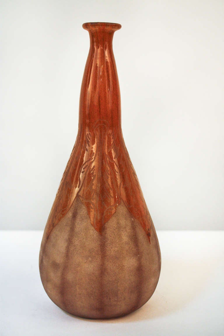 A wonderful Art Deco cameo glass vase. Created in France, this acid cut vase includes beautifully etched details on the top orange layer. A great piece.