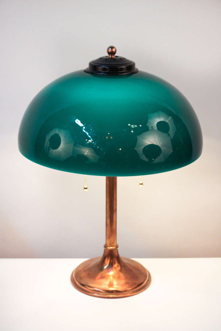 An elegant American desk lamp. Created by noted lamp makers The Miller Company: a double light piece, this lamp features a beautiful brass base. A vibrant green cased shade tops off this stunning piece.