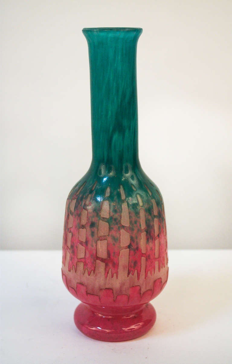 A beautiful Art Deco vase. Made in France during the 1930's, this acid cut vase features three vibrant colors.