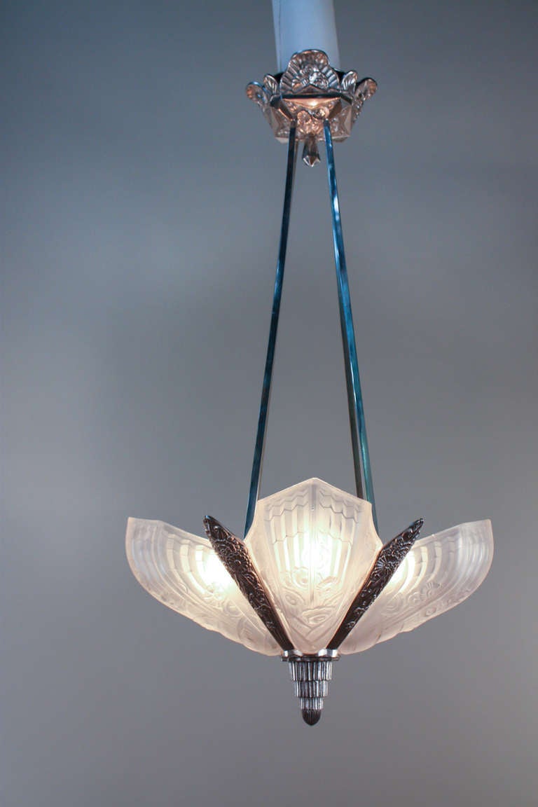 A beautiful four light Art Deco chandelier. This elegant chandelier features an ornate floral design on both the frosted glass shades and the classic nickel on bronze body. A fantastic chandelier. 

If you have any questions about this item,