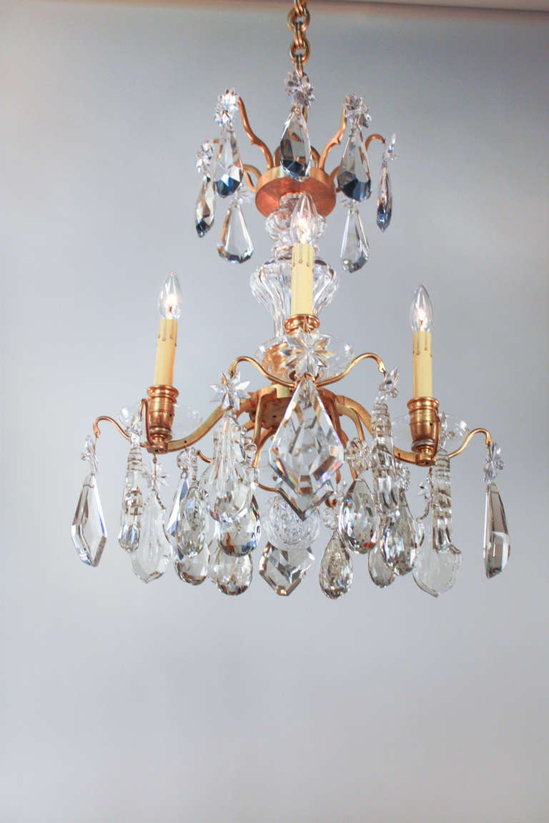 This is an absolutely fantastic chandelier. Dozens of gorgeous sparkling crystals hang from the beautiful gold plated bronze doré body. 

This quality of this chandelier is truly spectacular. An artisanally crafted crystal center column (see image