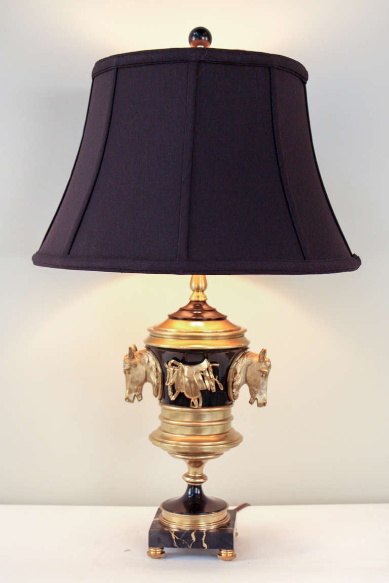 A beautiful table lamp with a unique history. Originally a horse racing trophy, this piece has been custom converted and electrified, resulting in a gorgeous table lamp.

Mounted atop a black marble base; this two color piece features a black