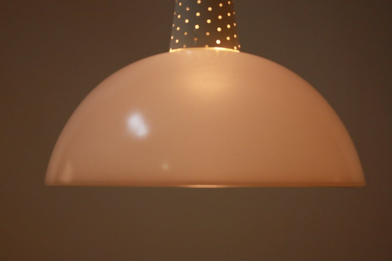 Beauty through simplicity is the manifesto of the modernists, and this mid-century pendant light is a perfect example of just that. 

A modernist European pendant light, this fixture features both clear and fogged glass. Wonderful off-white enamel