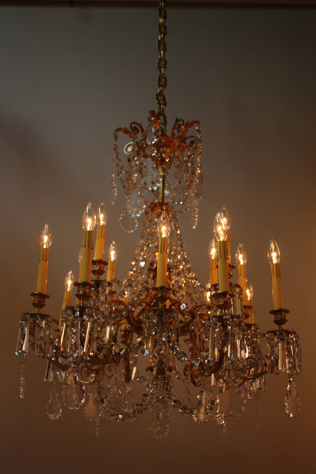 This stunning 19th century chandelier from France is made of beautiful bronze and crystal. With sixteen lights, this fixture is the definition of elegance.