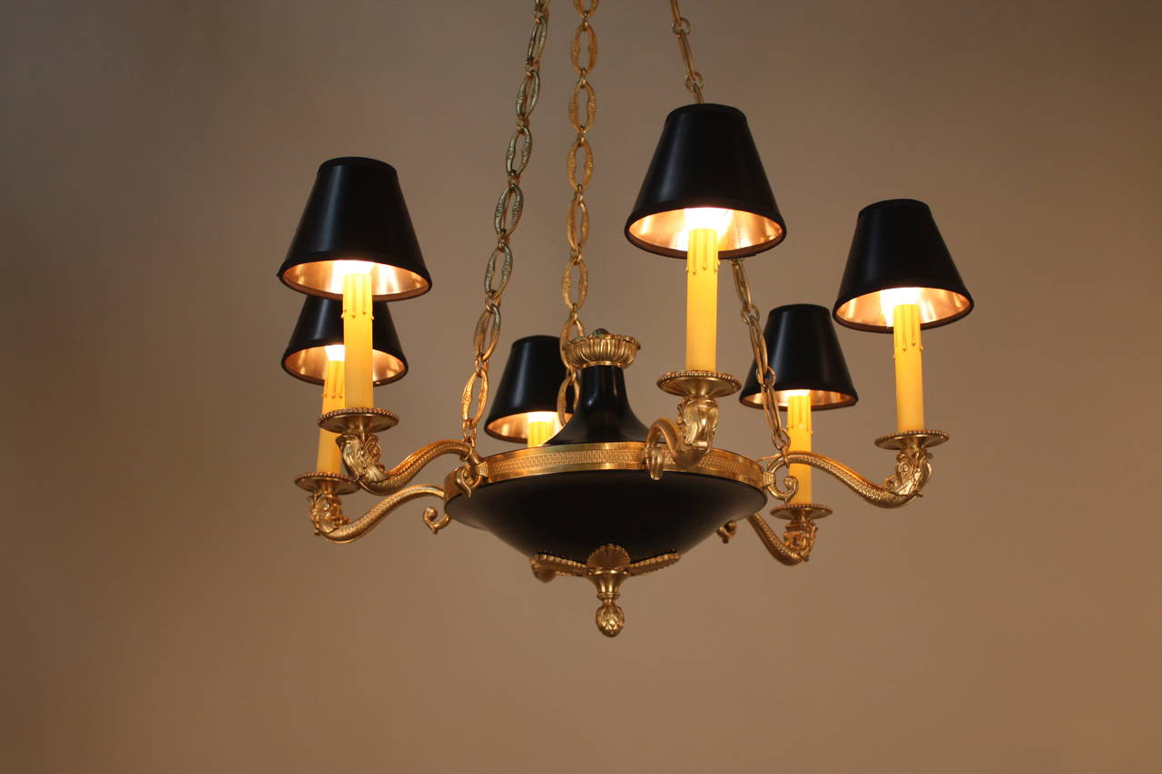 Crafted in France during the 1930s, this stunning chandelier features six lights and fantastically detailed bronze work and a beautiful black lacquer body.