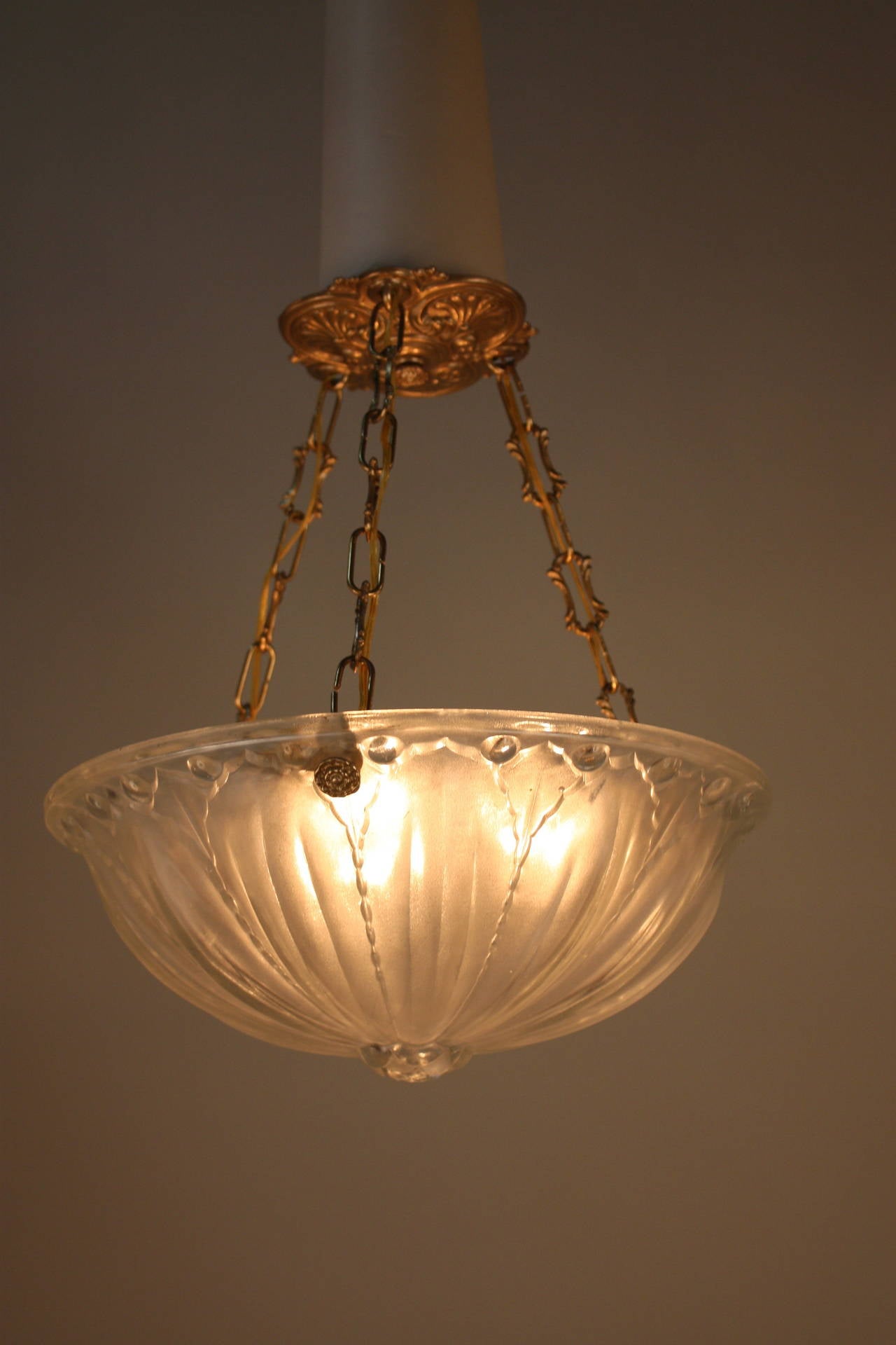 A beautiful French Art Deco pendant light. Made of glass with nickel on bronze chain and canopy.